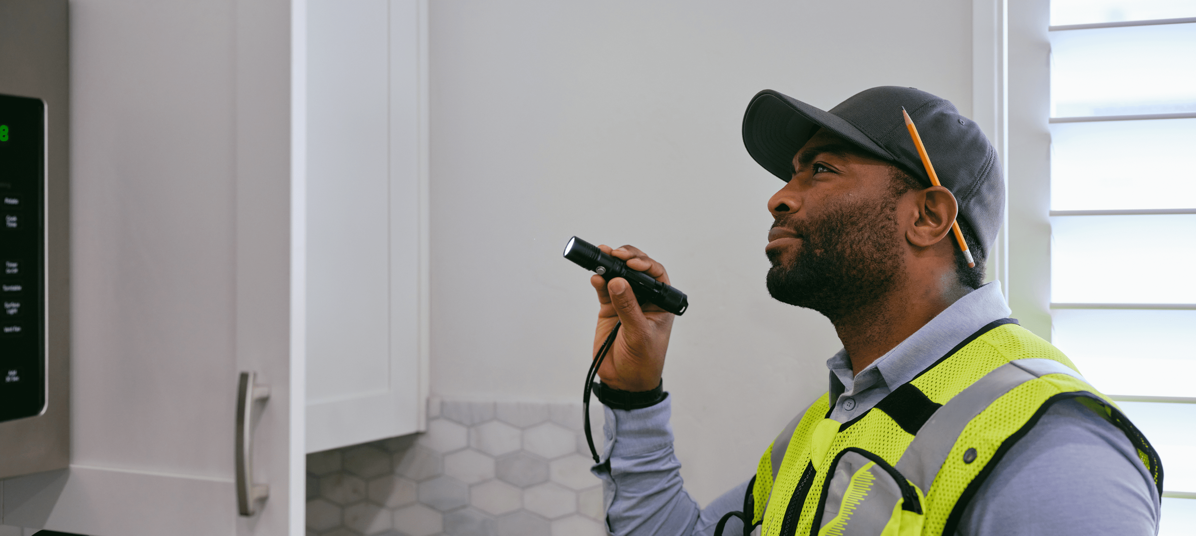 Inspector examining kitchen with flashlight